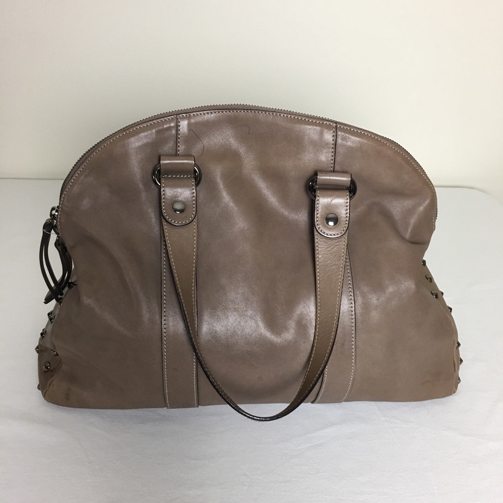 ASIA BELLUCCI tan satchel with stud detailing.